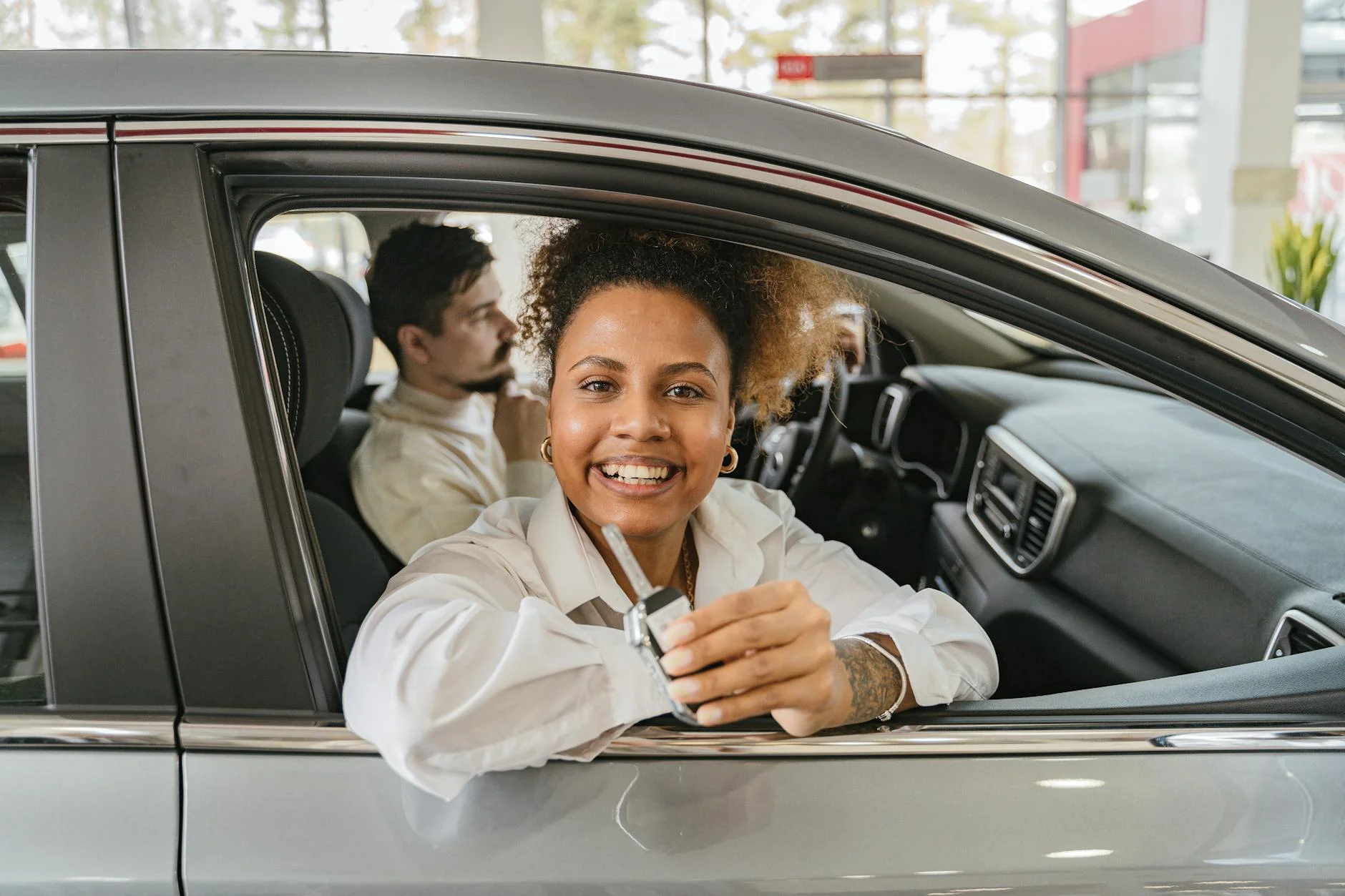 Handing over the keys to a newly financed car at a German dealership